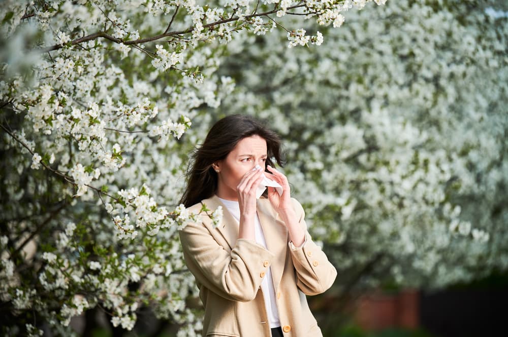 woman allergic suffering from seasonal allergy